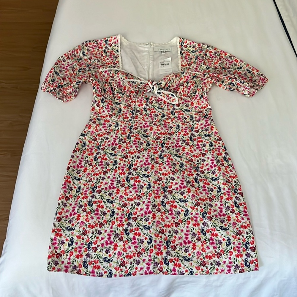Sweet and sexy summer dress with detailed neckline and cut out.
